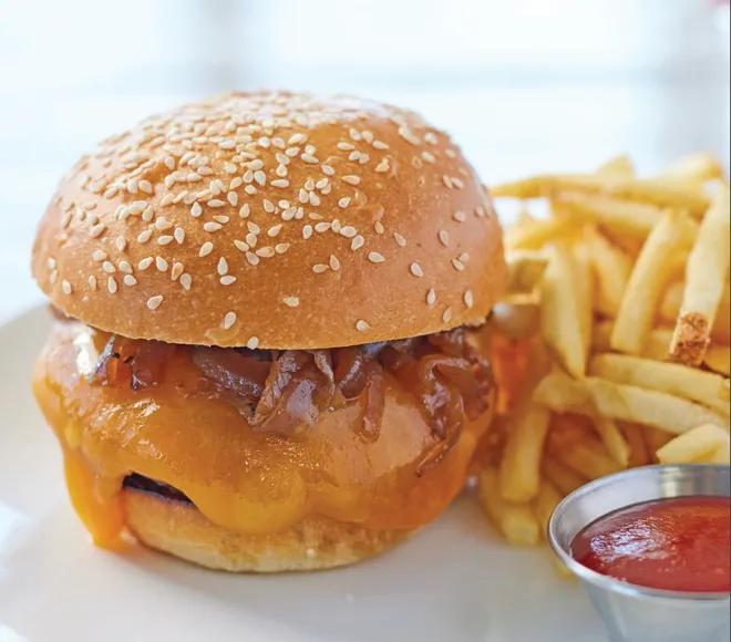 A cheeseburger with bacon and a side of french fries by Lessing's Hospitality Group. Provided By The Village Of North Palm Beach.